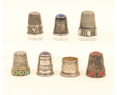 Seven silver and white metal thimbles, comprising; an example stamped "800" with 'turquoise' jewelled frieze, another similar