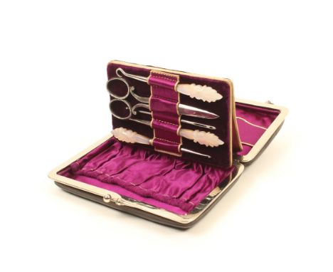 A late 19th century sewing companion, modelled as a handbag with plated frame and catch, on a curved handle, the purple silk 