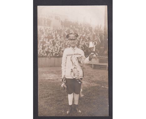 Football postcard, Tottenham Hotspur, photographic postcard showing a fan standing on the pitch with large crowd behind, dres