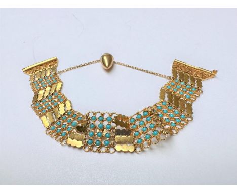 A Syrian/Arabic 21 carat yellow gold wide articulated chain link panel bracelet set with turquoise paste cabochons. The slidi
