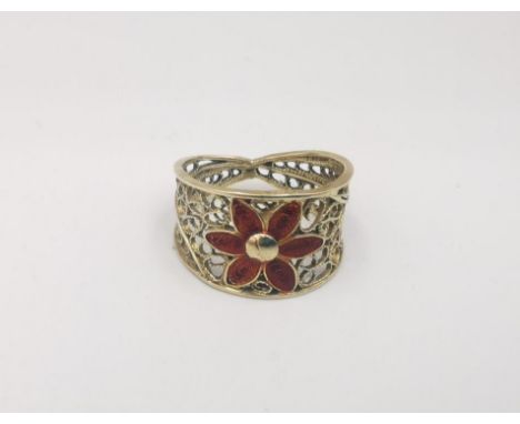 A 14ct yellow gold enamel wire work floral ring. Red enamel flower to the front, stamped 14K Ring size K. Weight 2.7g. 