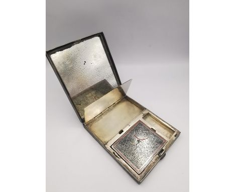 An early 20th century Indo-Persian silver plated engraved and enamelled travel compact with mirror. The interior with two spr