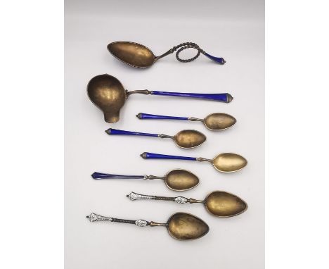 A collection of Norwegian gilded silver and royal blue guilloche enamel and white enamel spoons, including a caddy spoon with