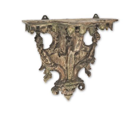 A paint-decorated softwood wall bracket, in the French Regence mannerThe bow-breakfront shelf hung with lambrequins above a t