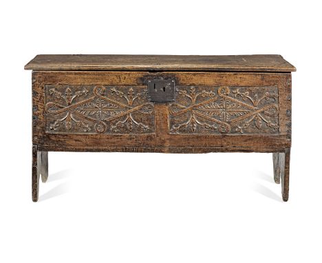 A mid-17th century oak boarded chest, English, circa 1650Having a single-board hinged lid, the front carved with two reserves
