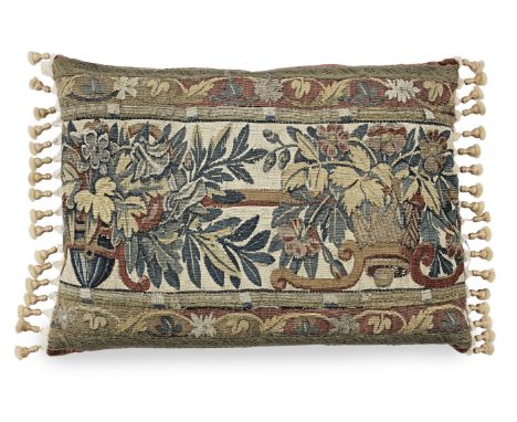 A 17th century tapestry cushionDesigned with floral bands in coloured wools and silk, with metallic braid edge and ivory tass