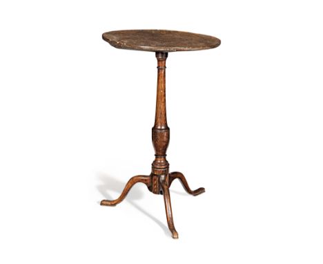 A George III elm tripod table, circa 1770Unusually tall, having a dished one-piece circular fixed top, a slender vase-turned 