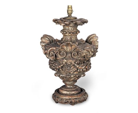 A carved and painted table lamp, with traces of gildingThe central section probably 18th century, carved as an urn with shell