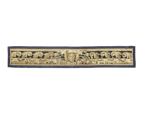 A 17th century tapestry table runnerWoven in mainly blue and brown wools, designed with a band of leafy scrolls centred by a 