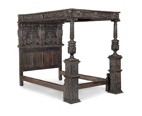 A James I joined oak tester bed, circa 1610Having a foliate-carved and boss dentil-moulded centred nine-panelled tester, poin