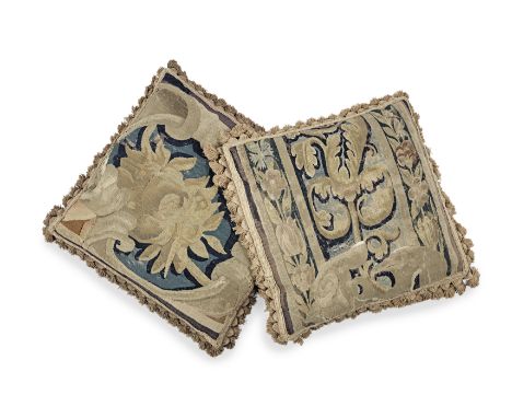 A pair of cushions made from 17th century tapestryEach woven in shades of brown and blue wools in a scrolling floral design, 