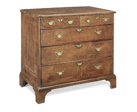 A rare George II oak and inlaid chest of drawers, dated 1731The impressive single-piece top inlaid with the date '1731', with