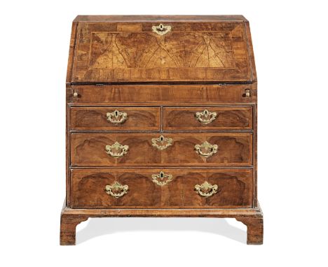 A George II walnut and featherbanded bureau, circa 1740Having a crossbanded and well-figured sloping fall, enclosing a tradit