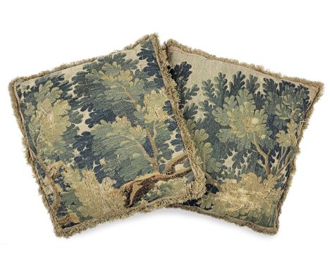 A large pair of cushions made from 17th century verdure tapestry, FlemishEach woven with a leafy-branch design, in shades of 