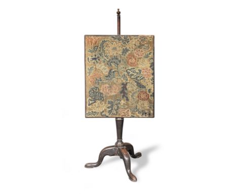 A George II mahogany and needlework pole firescreen, circa 1730The screen of floral needlework screen, worked in gros-point u
