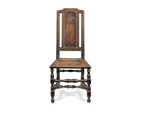 A joined oak side chair, English, circa 1700Having an ogee-arched back panel, a flattened-arch cresting, and channel-moulded 