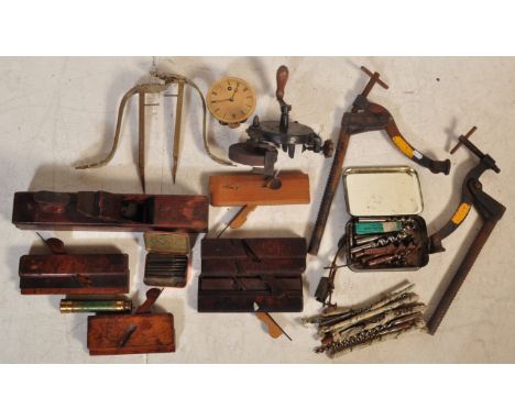 Collection of vintage 20th century wood working planes tools. The lot to include wood planes, hand held grindstone, drill bit