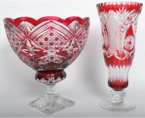 Two vintage 20th century ruby flash glass ornaments comprising of a vase of tapering form having etched star decoration raise