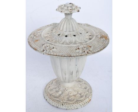 A late 20th Century cast iron garden planter urn. The urn having a round base with scrolled details with a tapering reeded bo