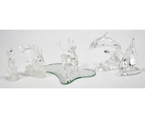 A group of Swarovski crystal animals. The lot to include a Butterfly fish (162888), a seahorse (168683),a dolphin (190365), a