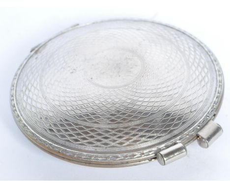 A vintage 1940's silver plated Plaza cigarette lighter/. The lighter being of circular compact form with engine turned guillo
