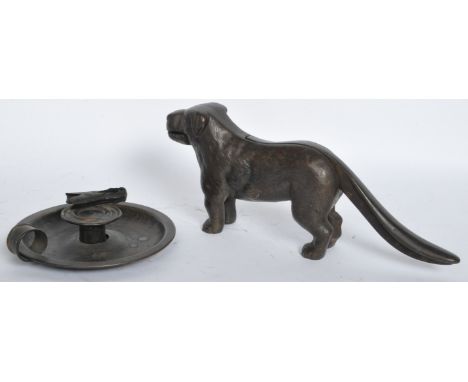 A vintage 20th century nutcracker in the form of a dog together with a 19th century Victorian chamber stick / candle holder.&