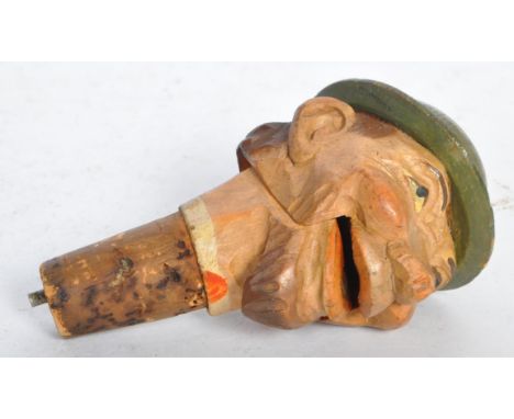 A vintage mid 20th century German painted carved wood treen novelty wine bottle stopper &amp; pourer in the form of a man wea