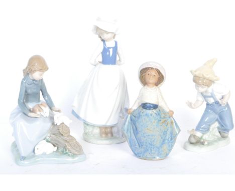 A collection of four vintage 20th century Nao Spanish porcelain figurines. The set to include Boy with Birds on Toe, a girl w