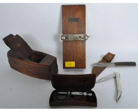 A collection of early 20th century gentleman's tools to include a Garlick &amp; Sons tie press, a block smoothing plane, a st