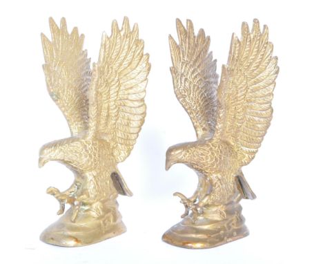 A pair of vintage 20th century brass eagles desktop ornaments. The eagles having outspread wings on a naturalistic base. Each
