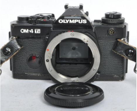 A 1980's Olympus OM-4 Ti camera body. Model no. 1164409 with lens cap and leather neck strap.&nbsp;