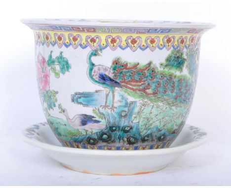 An early 20th century Chinese hand painted porcelain planter with accompanying under dish. The pot being decorated with peaco