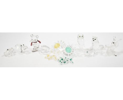 A collection of swarovski crystal figurines. The lot to include a hippo ( 151737), a cat, a clam shell, a frog, an owl, a ted