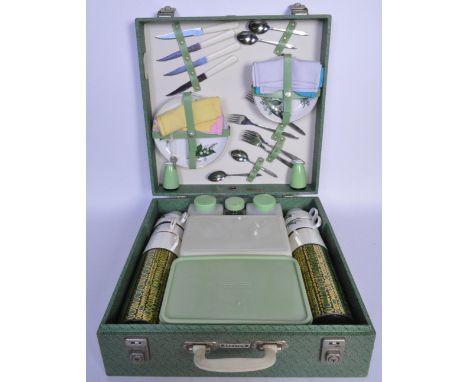 A vintage retro 20th century circa. 1960's wicker picnic basket hamper with fully appointed interior having flask, Tupperware