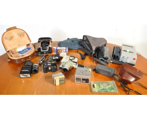 A collection of vintage 20th century cameras comprising of a Minolta Zoom 8, Hitachi EIS camcorder, Leitz projector and more.