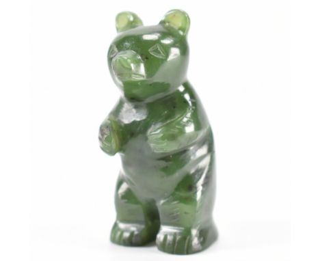 A vintage 20th century nephrite jade green stone figurine of a standing bear having hand carved features. Measures 54mm high