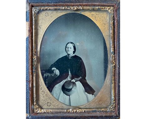 A collection of 16 Victorian daguerreotype, ambrotype and tintype photographs, framed, together with an oval enamel photograp