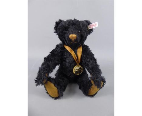 A Steiff Black Mohair "Bear of the Year 2014" Teddy. The bear is sports a "gold" medallion around his neck and was made exclu