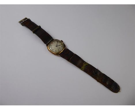 A 9ct Yellow Gold Gentleman's Wrist Watch, the watch having a white engine turned face with numeric dial, fifteen jewel Swiss