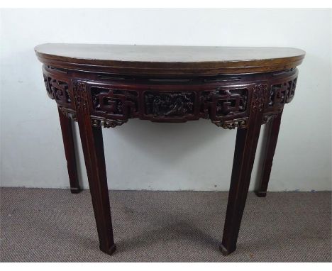 A Chinese Late 19th Century Demi-Lune Console Table, Chinese Camphor wood, with a highly decorative carved frieze, the demi-l