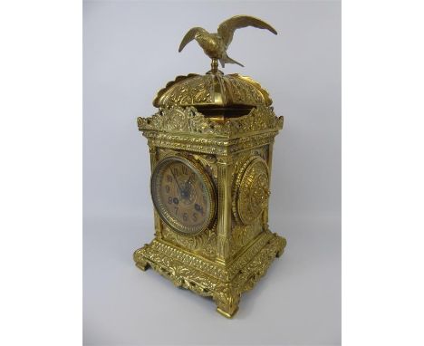 A French Brass Mantel Clock, brass face with numeric dial, strikes to coil, movement nr 3138, domed with bird finial, approx 
