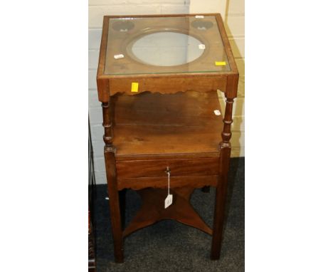 A George III mahogany washstand, with basin and brush provision over a frieze drawer on inner chamfered square supports unite