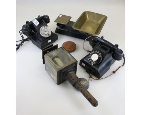 Two black Bakelite vintage 1930s/40s dial telephones, together with tongue press, postal scales and other metal wares
