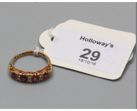 An Edwardian 18ct gold ruby and diamond half hoop ring, the four slightly graduated half oval cut rubies with two stone diamo