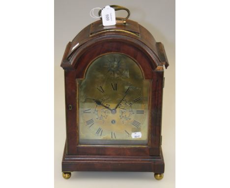 A late 18th century/early 19th century mahogany bracket clock, the arched case with brass plain scroll handle enclosing a sin