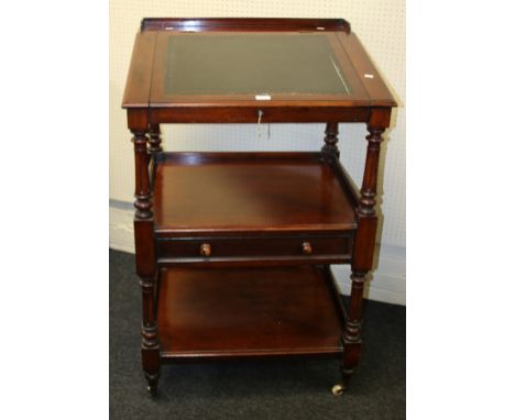 A late Victorian mahogany clerk's desk, the slope with hide scriber over two stages with central drawer within turned, fluted