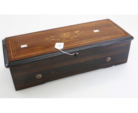 A Victorian rosewood and simulated cased music box, the hinged lid inlaid with harvest trophies enclosing a single cylinder p
