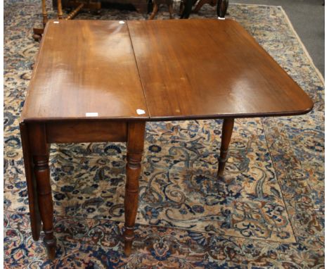 A Victorian mahogany gateleg dining table, the rectangular top and twin flaps with single gate on baluster turned tapering le