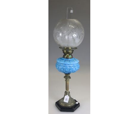 A late Victorian paraffin lamp, having a spherical etched shade over a turquoise moulded reservoir, square section leaf cast 