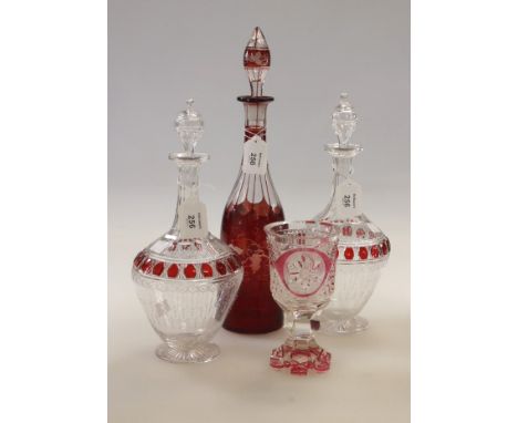 A pair of early 20th century Bohemian liqueur decanters and stoppers, each of baluster form with faceted neck, florally etche